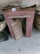 An old brick built model of a building with corrugated roof (probably an outside toilet).