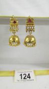 A pair of (test as 24ct gold) pendant earrings set rubies. 10.4 grams.