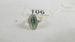 An oval yellow gold and emerald ring, size K half.