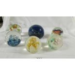 A large blue Mdina glass paperweight and 5 others.