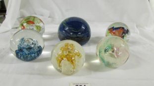 A large blue Mdina glass paperweight and 5 others.