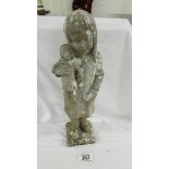 A weathered statue of a girl with doll signed D Torrioni, 13" tall.