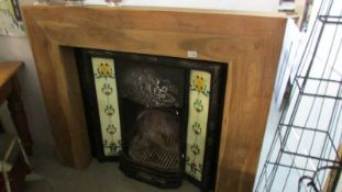 A good art nouveau style fire place in wooden surround.