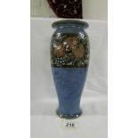 A Royal Doulton 27 cm high mottled blue vase with a band of grapes and another fruit near the top.