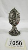 A Judiaca Russion lion topped stone set white metal filigree egg, Russian silver marks.