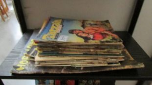 A collection of old comics including 21 Tarzan Adventures, Cowboy and others.