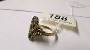 A 9ct gold green stone dress ring, size M.