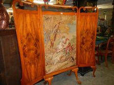 A large Victorian tapestry screen in and oak and walnut frame on pad feet.