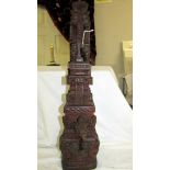 An intricately carved teak hardwood, probably Balinese, Hindu temple gate column carving.