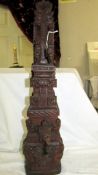 An intricately carved teak hardwood, probably Balinese, Hindu temple gate column carving.