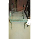 A wrought iron fireside lot cradle.