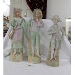 A pair of 37 cm continental bisque porcelain figures and a smaller (34cm) continental bisque figure.