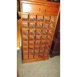 A stained pine wine rack. ****Condition report**** Height 123cm. Depth 32cm.