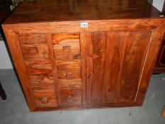 A single door cupboard with 6 spice drawers.