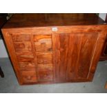 A single door cupboard with 6 spice drawers.