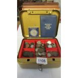 A cash box containing assorted coins.