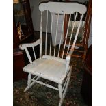A white painted rocking chair.