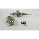 A silver 1906 babies rattle/teether and a silver plate rattle as a policeman.