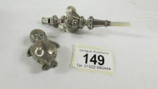 A silver 1906 babies rattle/teether and a silver plate rattle as a policeman.
