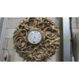 A large ormolu style gilded plastic wall clock with Jaeger quartz movement.