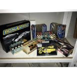 A quantity of boxed Scalextric cars and hand controllers.
