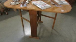 A drop leaf laminated table.