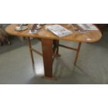 A drop leaf laminated table.