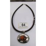 A silver and amber oval pendant fitted to a collar chain.