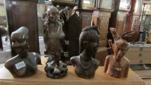 3 carved African busts and a carved Chinese Deity figure.