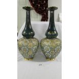 A pair of antique Royal Doulton 42.5 cm vases with bulbous bottom half and long slender necks.