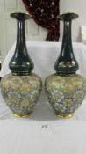 A pair of antique Royal Doulton 42.5 cm vases with bulbous bottom half and long slender necks.