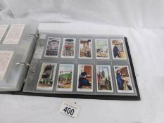 An album containing 11 sets of 1930's cigarette cards, Player's, Wills, Gallaher.