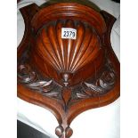 A carved wood shelf bracket.