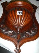 A carved wood shelf bracket.