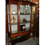 An Edwardian mahogany inlaid display cabinet with domed glass door.