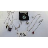 7 items of silver jewellery including pendants.