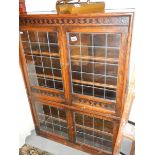 A four door oak lead glazed cabinet.