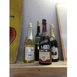 A bottle of Welsh cream liqueur and 3 bottles of champagne/sparkling wine.