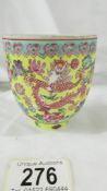 A Chinese eggshell porcelain yellow ground famille rose bowl (wine cup?),