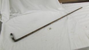 A ladies silver topped walking cane.