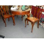 An oval mahogany dining table with four chairs.