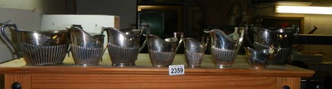 A mixed lot of silver plate milk jugs.