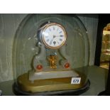 A good French alabaster mantle clock under dome with swinging cherub pendulum.