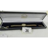 A 9ct gold ladies Avia wrist watch on 9ct gold bracelet, total weight 13.6 grams.