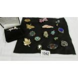 A quantity of vintage brooches on felt and a boxed pearl brooch.