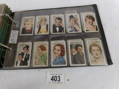 An album containing 12 sets of Player's, Wills, Gallaher cigarette cards.