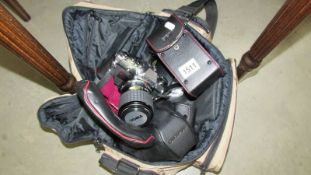 An Olympus OM10 camera and accessories.