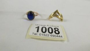 A 9ct gold ring set blue stone and a 9ct gold wishbone ring.