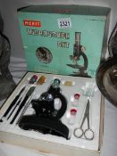 A mid 20th century Merit microscope, complete and in original box.