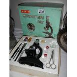 A mid 20th century Merit microscope, complete and in original box.